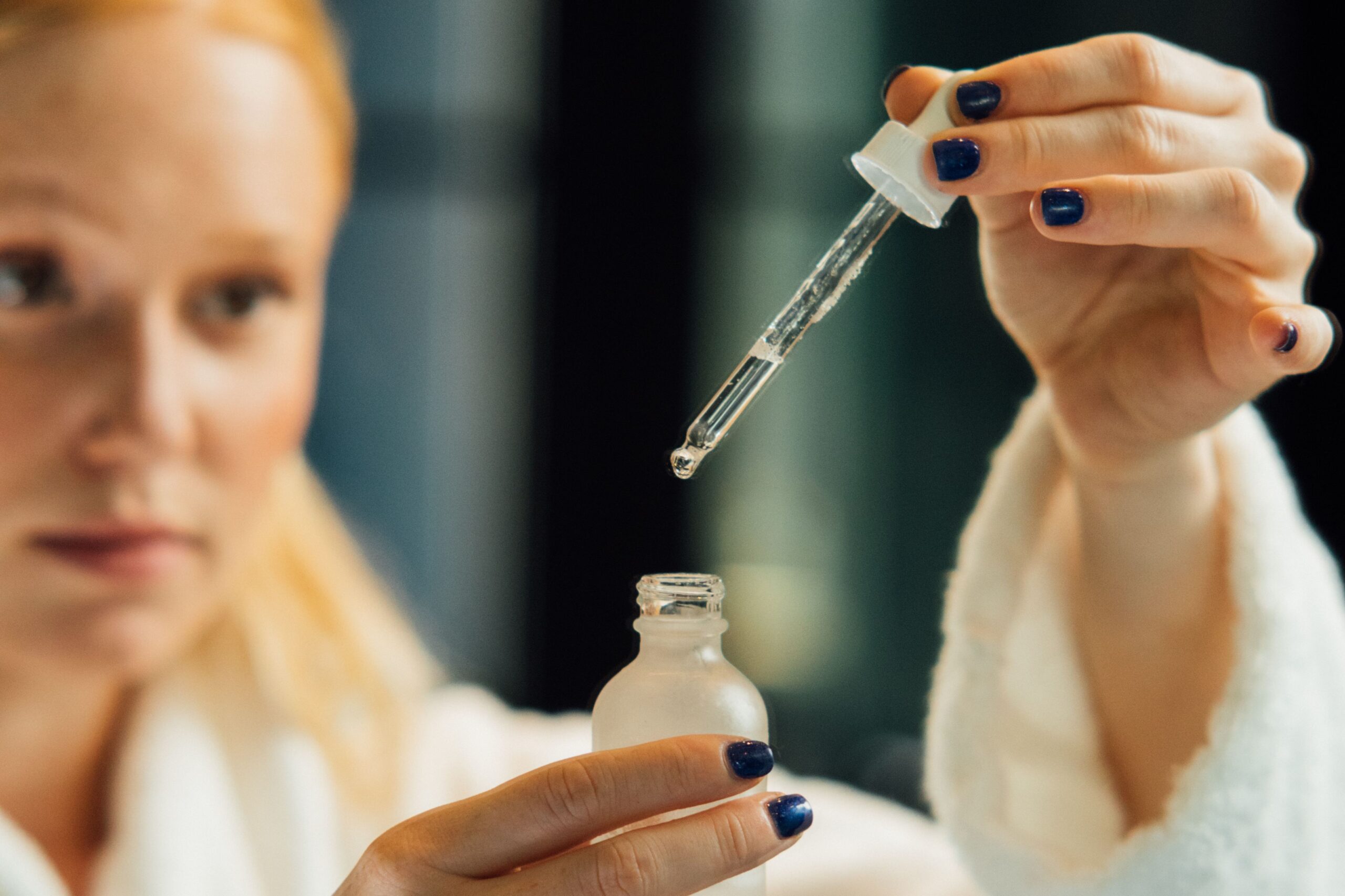 A woman using a tranexamic acid skincare serum
